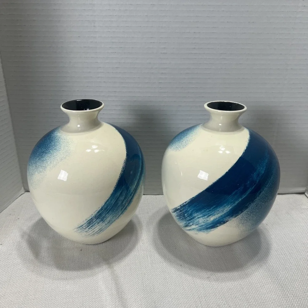 Pair of decorative blue, gold, black and Cream ceramic bottle vases